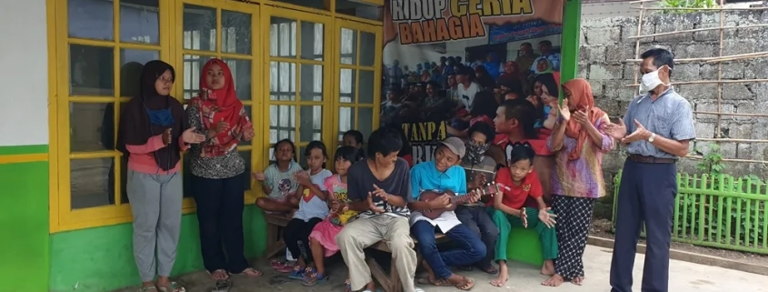 Children gather outside the shelter in Depok in West Java. The building offers a place of refuge [Jessica Washington/Al Jazeera]